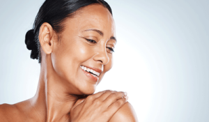 Woman feels her shoulder after going through skin healthcare services